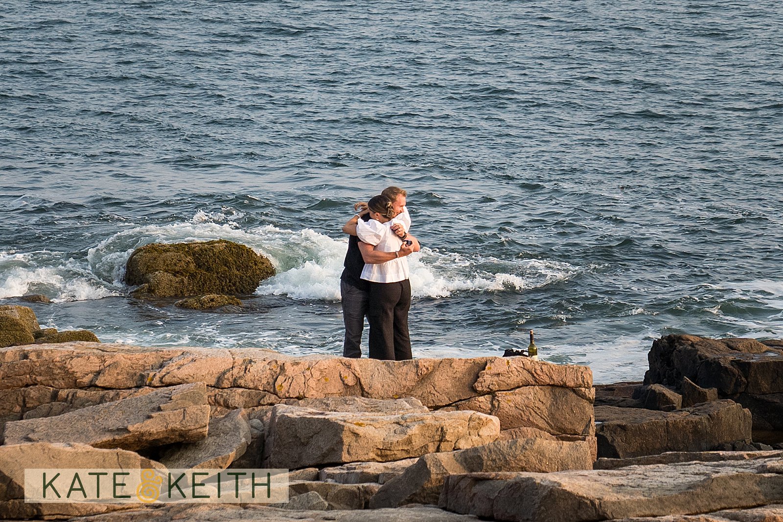 Newly engaged couple hugging in Acadia National Park