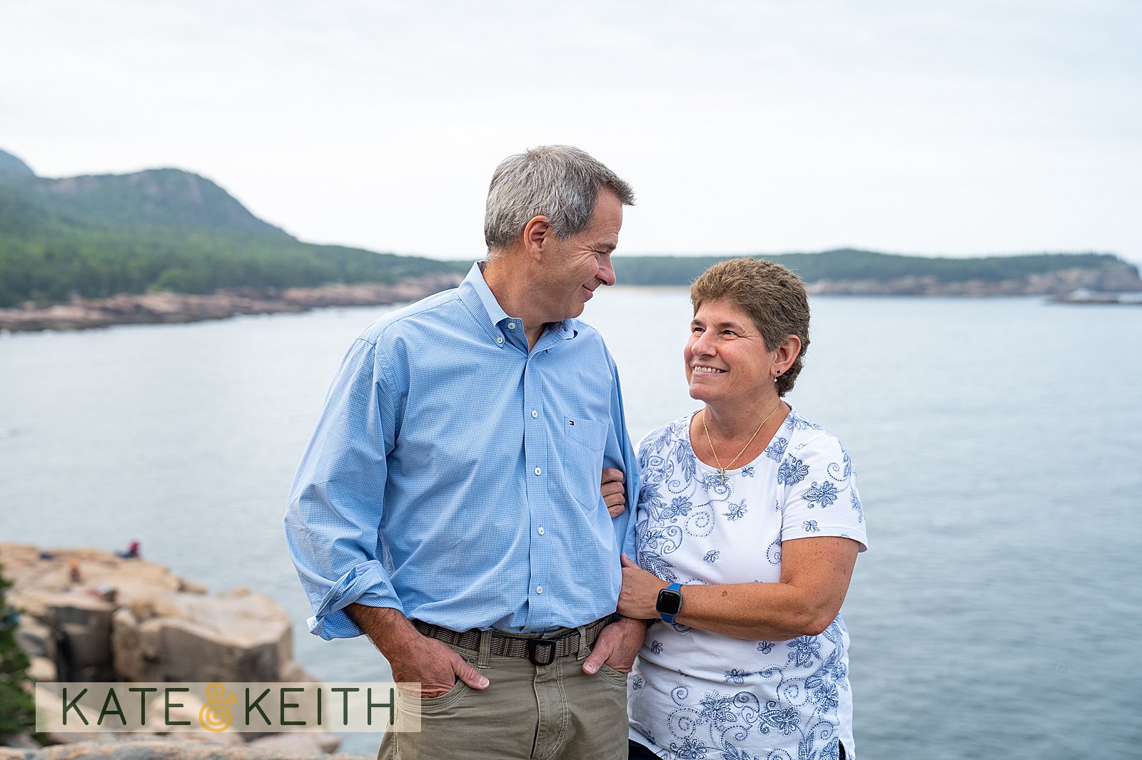Grandma and Grandpa smiling at each other on the Acadia coast