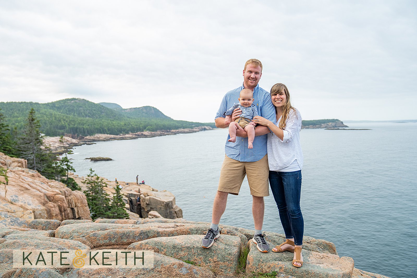 Mom, Dad and baby posing on the rocks of the Acadia National Park coastline