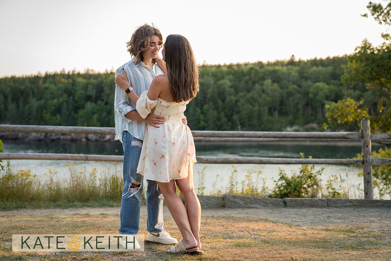 newly engaged couple with the ocean behind them
