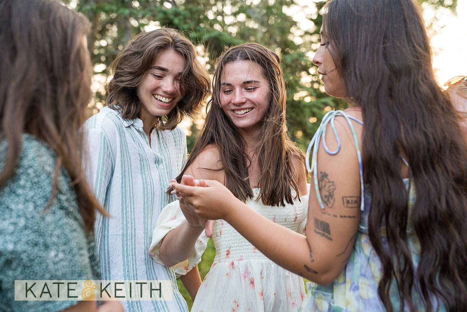 a woman showing off her engagement ring to friends
