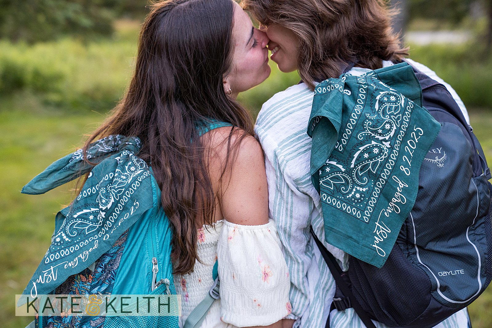 inclusive Acadia National Park proposal photography with two women kissing and a close up of their Just Engaged bandanas