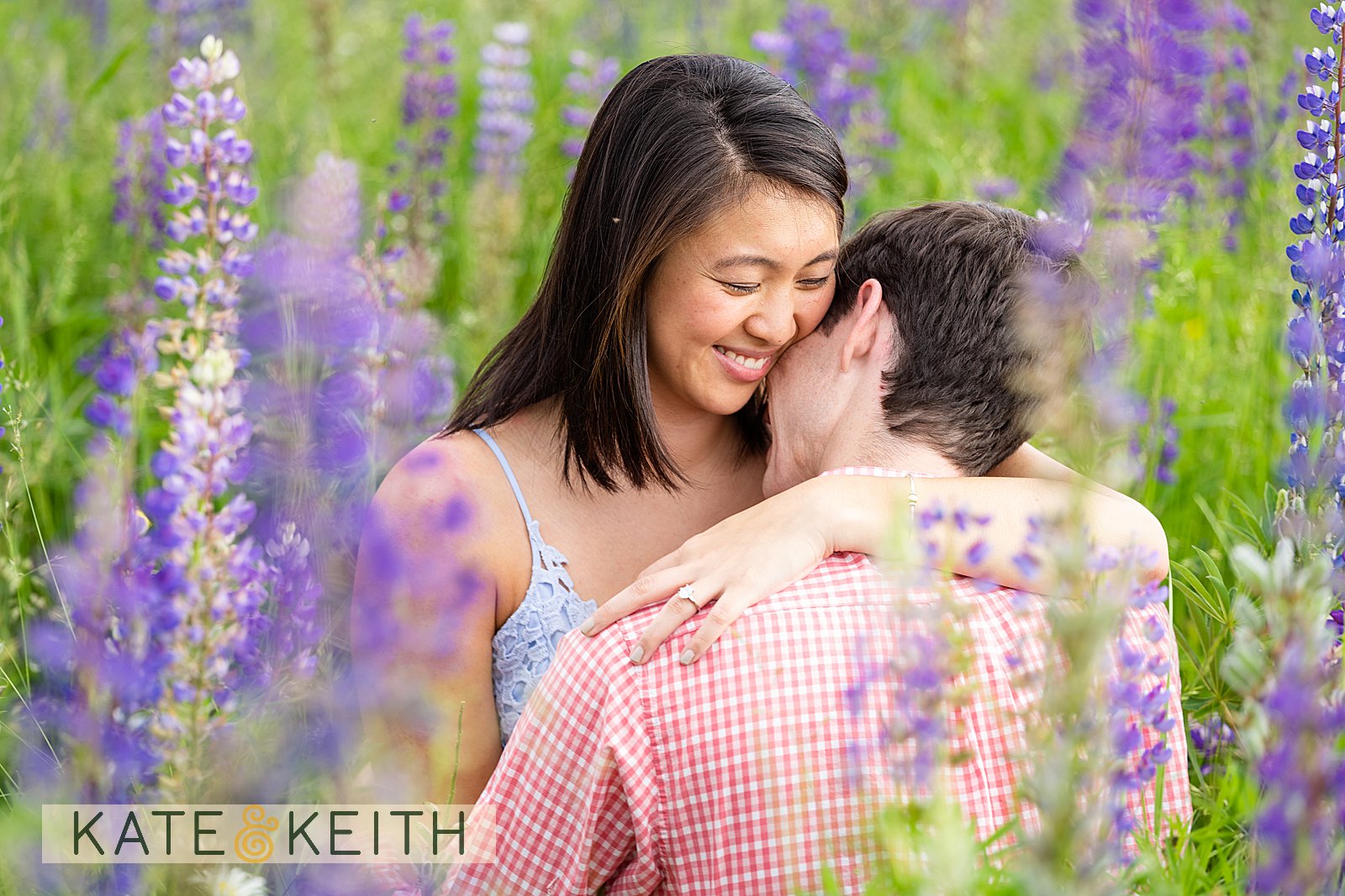 Couple celebrating engagement in Acadia lupine fields